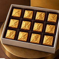 Twelve gold wrapped chocolates in a box