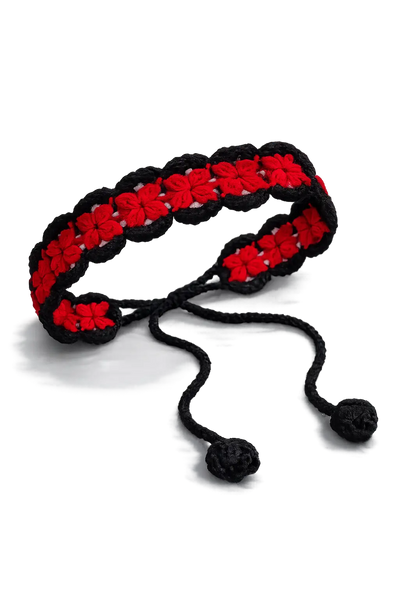 Red and black crochet headband with black tie cords ending in bobbles