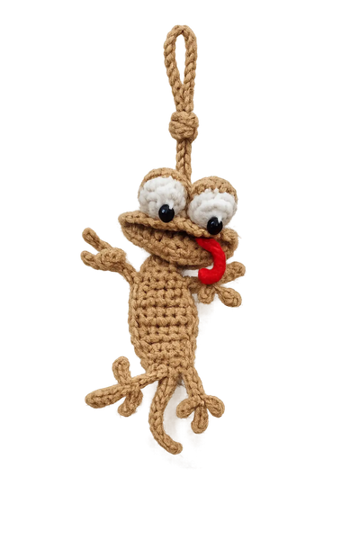 Brown crochet lizard car hanging with googly eyes and a red tongue, on a looped cord