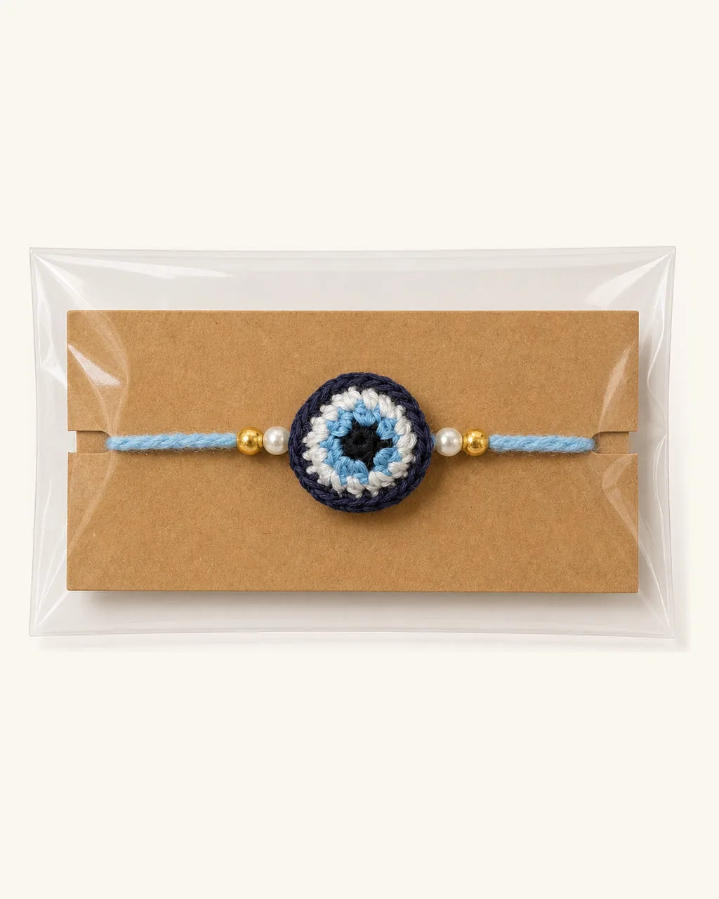 Blue Evil Eye Crochet Rakhi in its gift sleeve