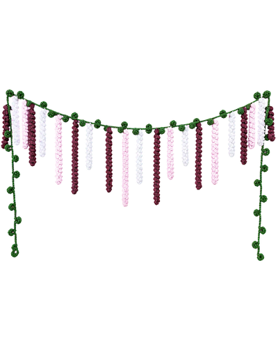 Handmade crochet vandanvar with deep maroon, pink and white flower strands hanging from a green pom-pom vine