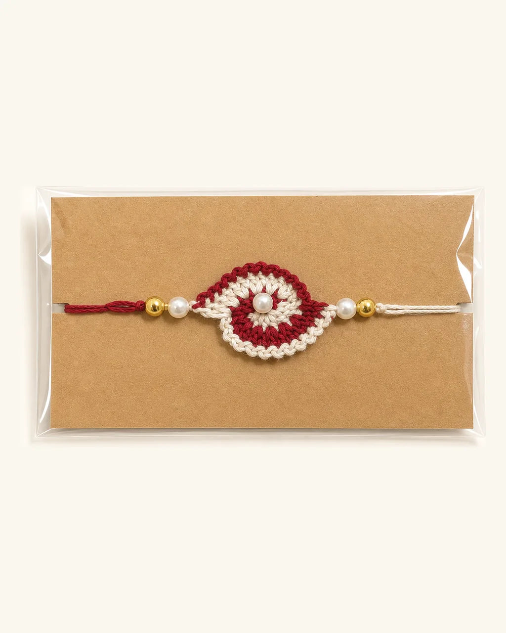 Dark Red Swirl Crochet Rakhi in its gift sleeve