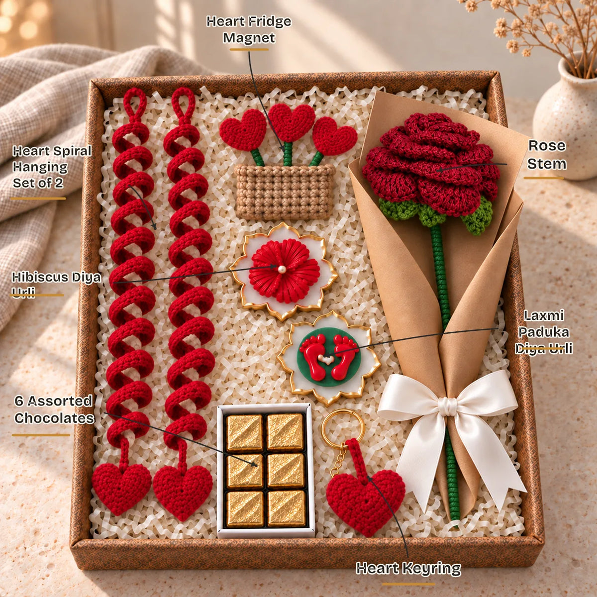 Labelled contents of the Dilwali Festive Hamper: heart spirals, heart magnet, rose, heart keyring, chocolates, 2 urlis