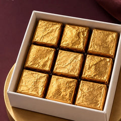 Nine assorted gold foil chocolates in a 4 inch box