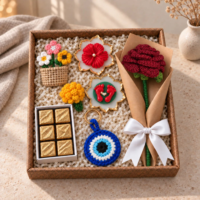 Ghar Ki Festive Hamper box: kraft-wrapped red crochet rose, evil eye keychain, marigold, chocolates and diya urlis